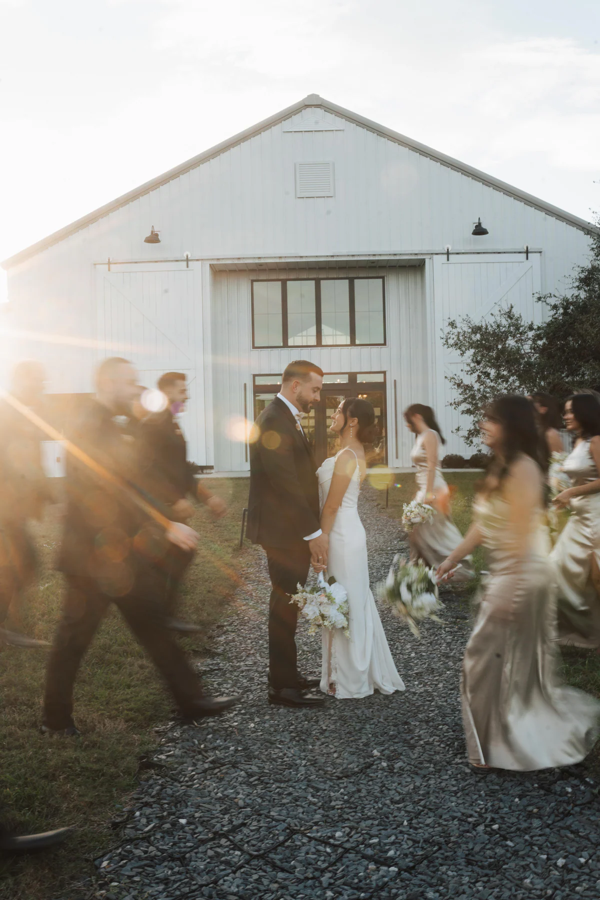 A wedding party gathered together in warm sunset light