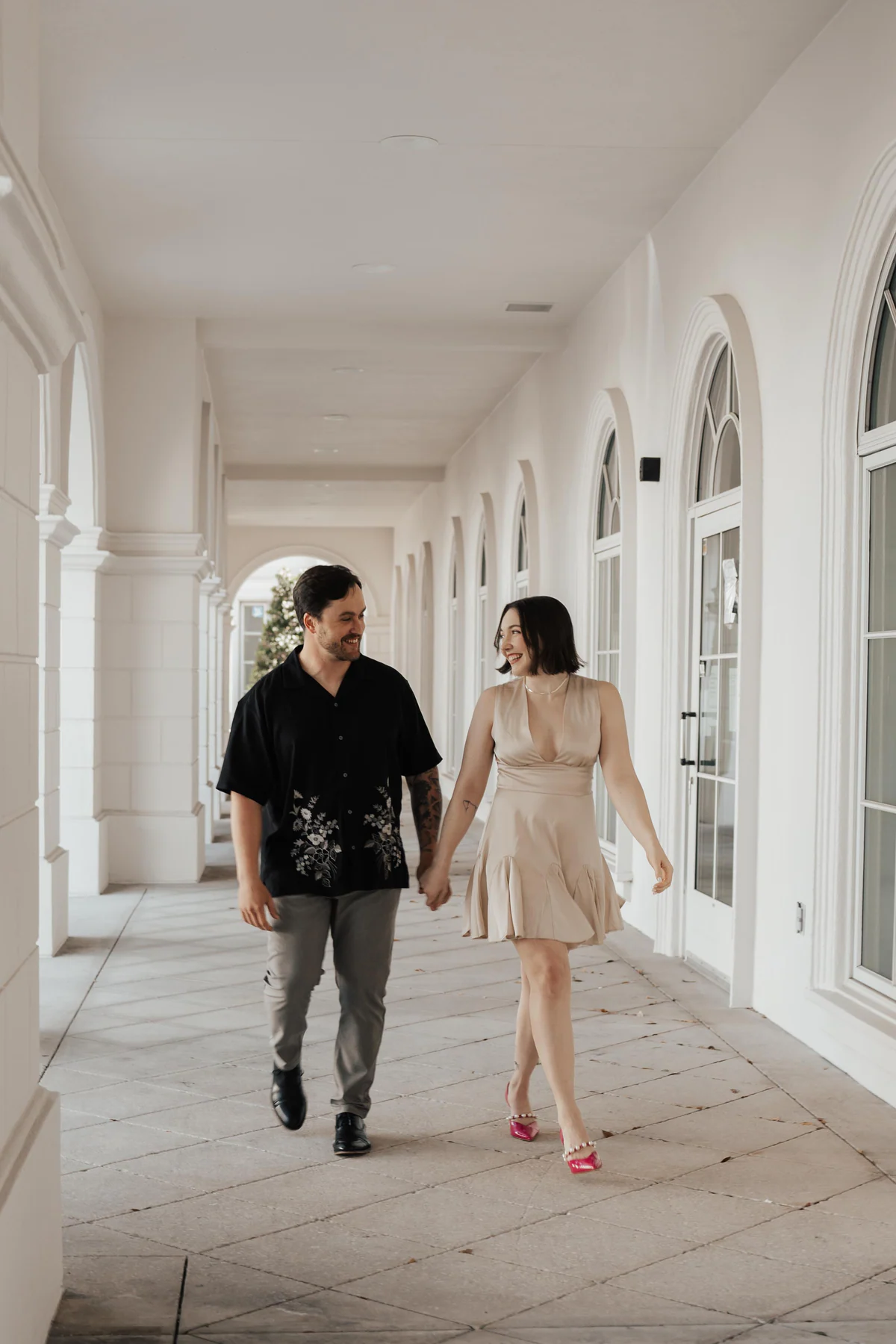 Orlando engagement couple walking through a bright venue
