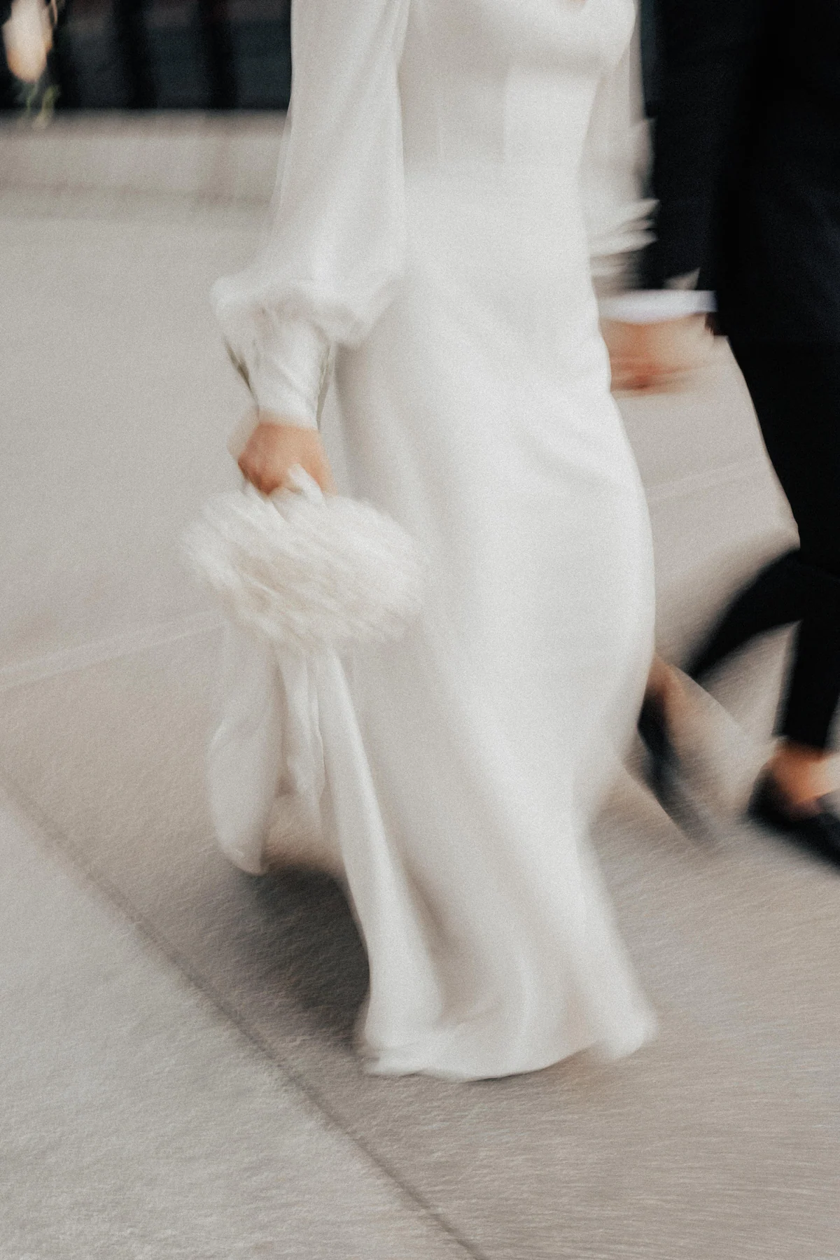A bride’s gown in motion as she walks with her groom at Four Seasons Resort Orlando
