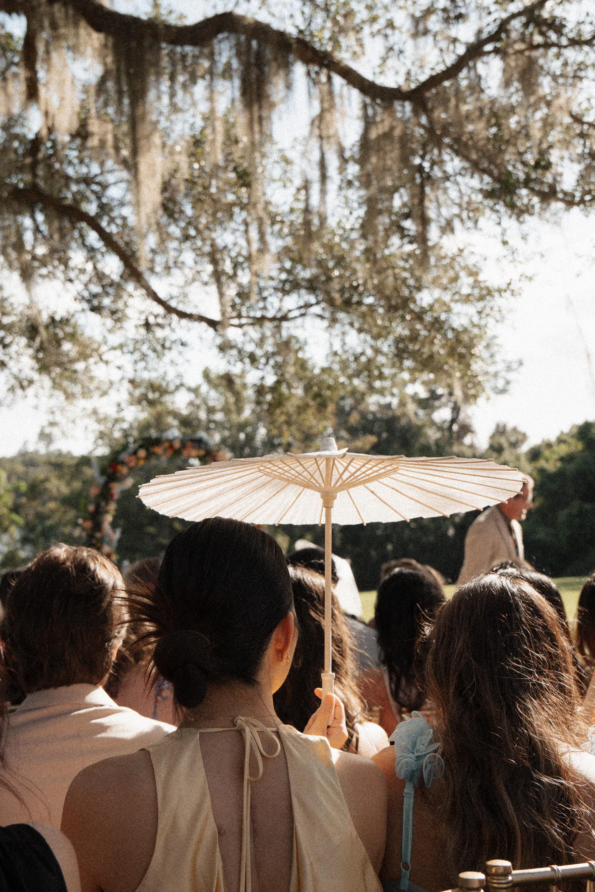 Guests gathered for an outdoor ceremony under Florida oaks at a Four Seasons Resort Orlando wedding