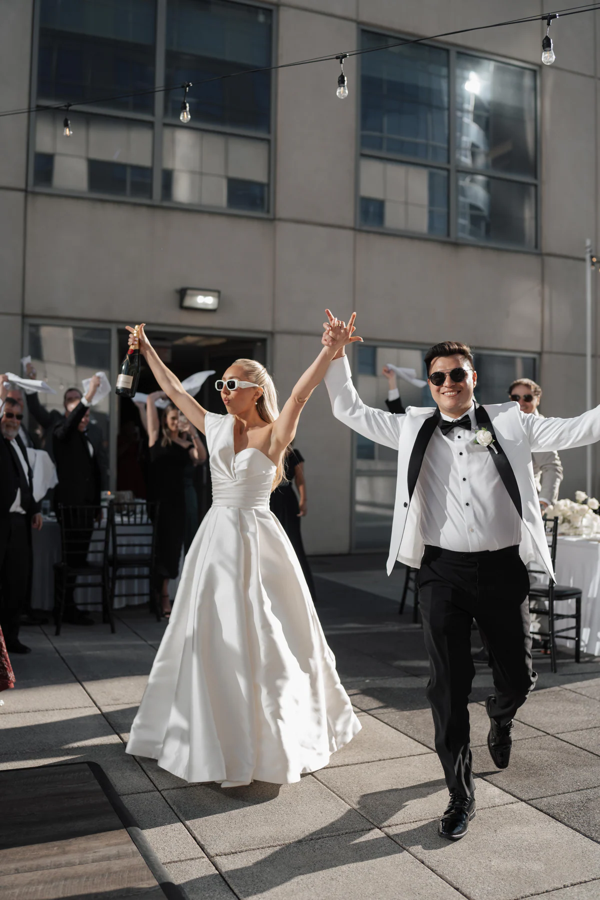Newlyweds making their joyful entrance into their Four Seasons Resort Orlando wedding reception