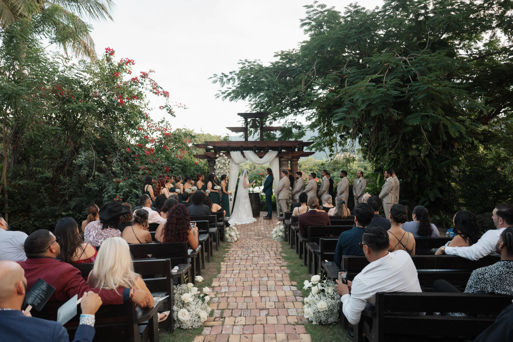 Abigail and Cody’s ceremony on the brick terrace at Hacienda Siesta Alegre, seen from the back of the aisle
