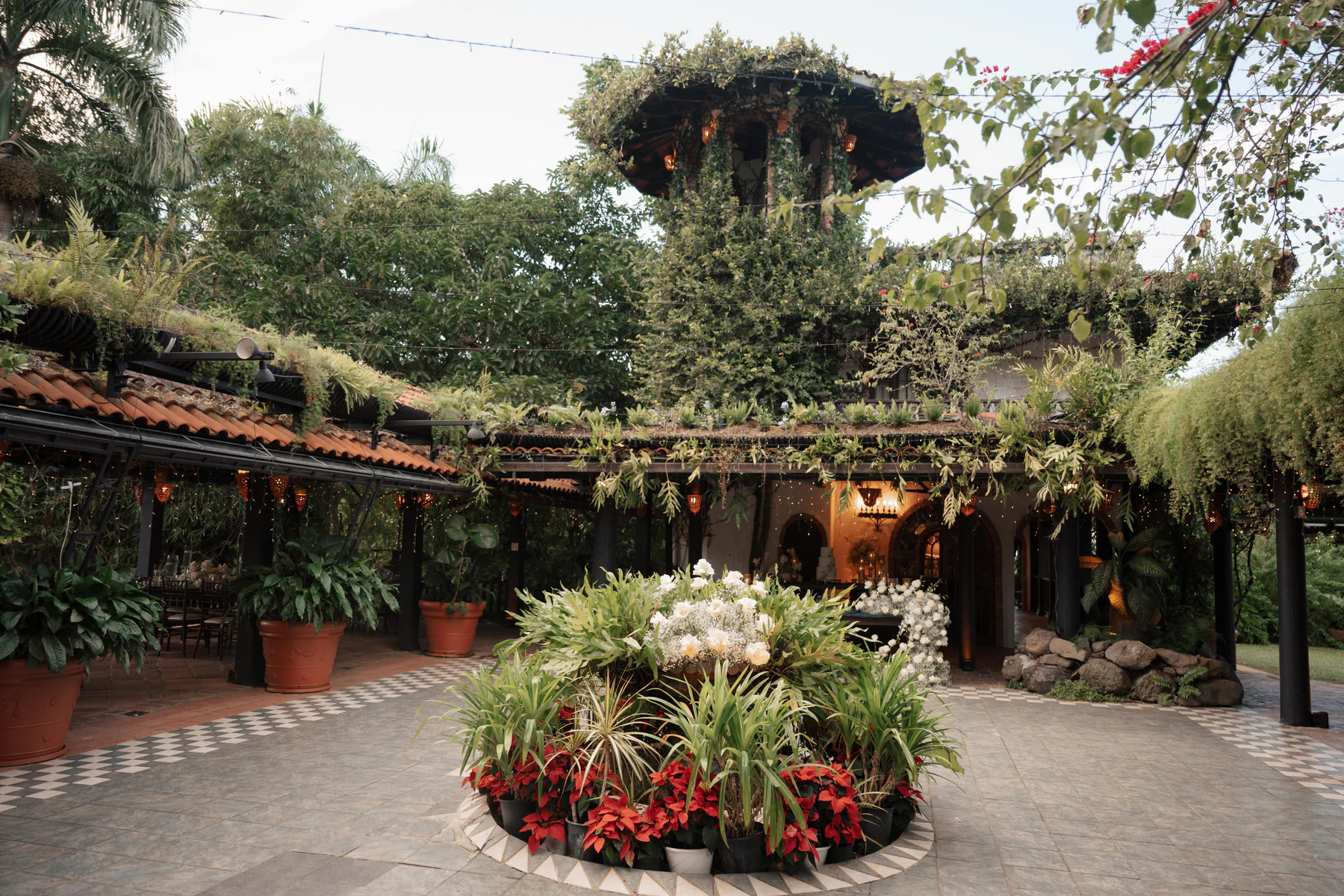 The courtyard and tower at Hacienda Siesta Alegre, framed by gardens and the circular planter at its center