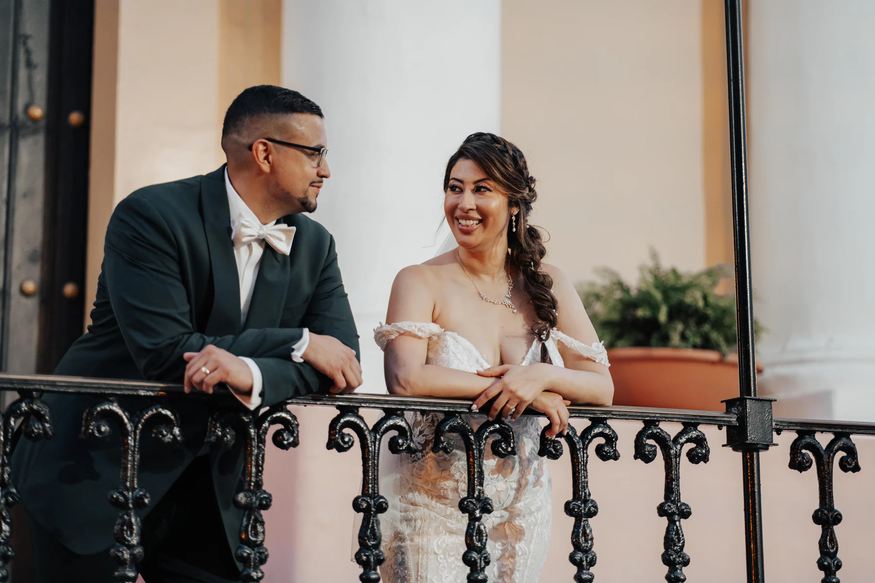 Alexandra and Freddie laughing together on a balcony at Hotel El Convento