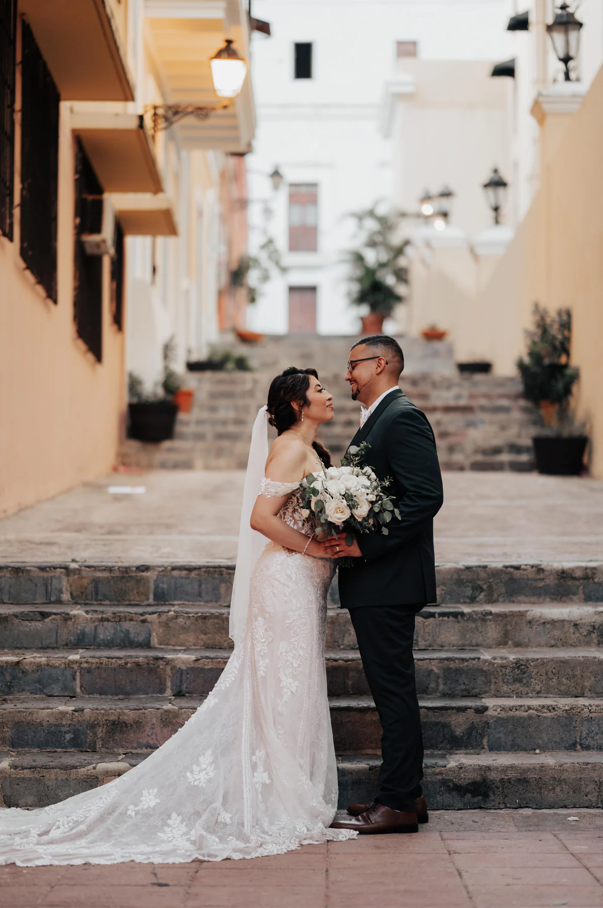 Alexandra and Freddie on the stone steps of the alley beside Hotel El Convento in Old San Juan