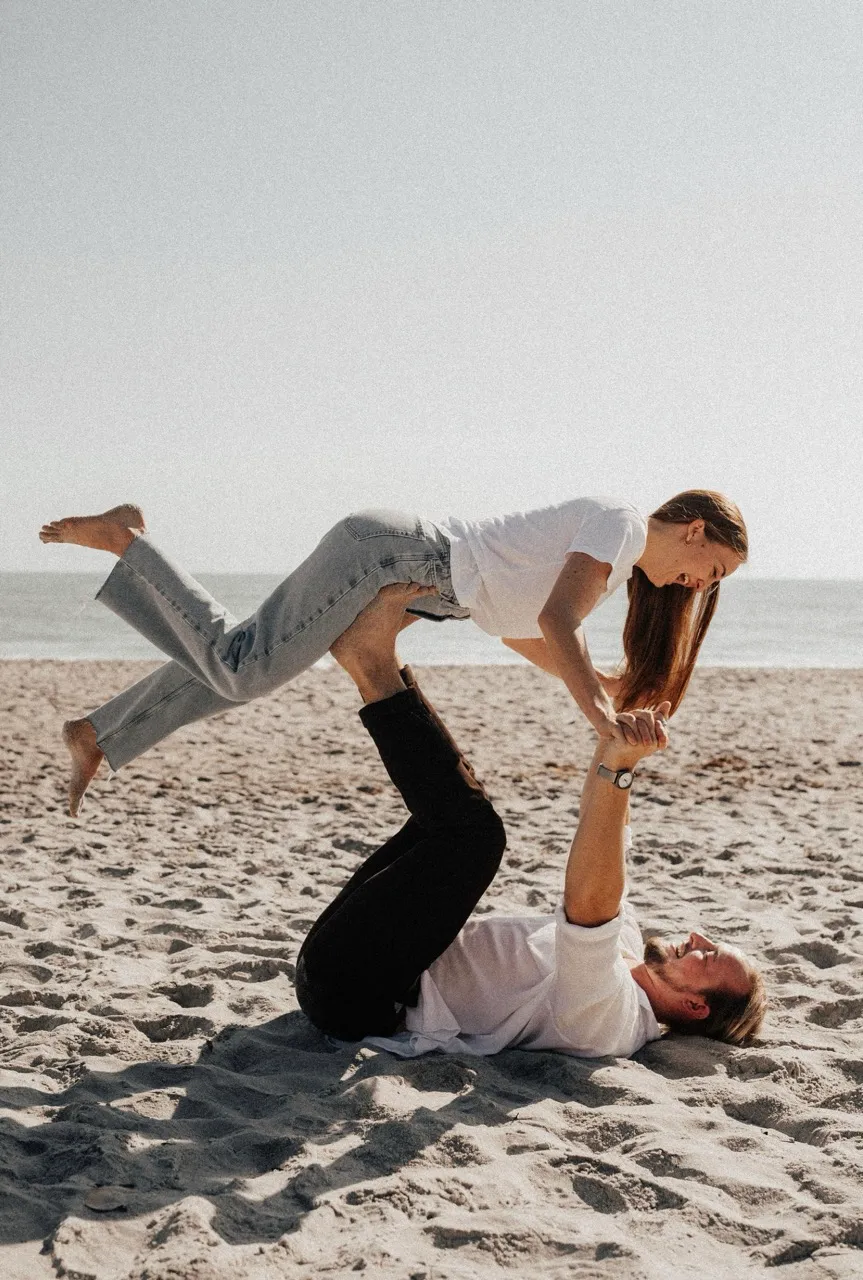 Couple playing on the beach.